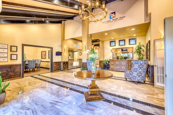 Bright and inviting lobby with seating area and floral arrangement