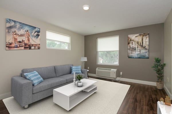 Stylish living room with gray couch and art.