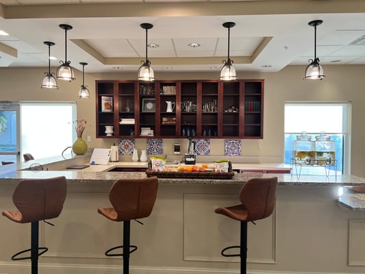 Modern kitchen with bar stools and decorative shelves