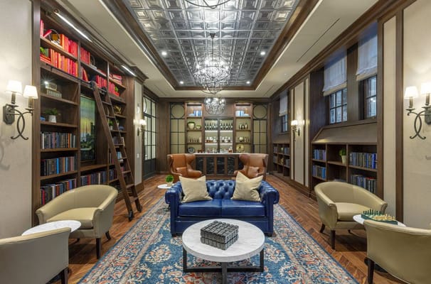 Interior view of a cozy lounge with bookshelves and comfortable seating