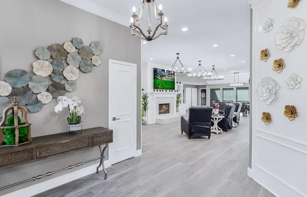 Brightly lit lobby with decorative wall art and seating area