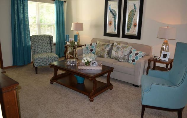 Comfortable living room with teal curtains and decorative pillows
