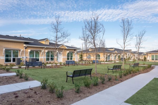 Scenic courtyard with benches and landscaped areas at Springwood at Allen