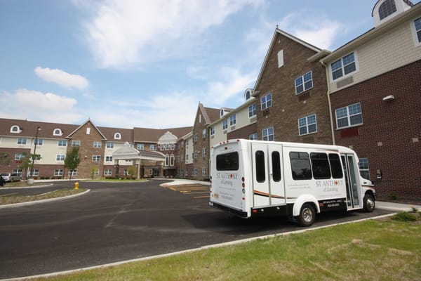 St. Anthony of Lansing entrance with shuttle bus parked
