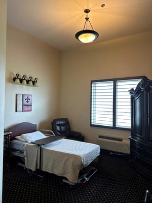 Cozy resident room with a bed and armchair