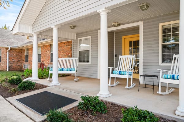 Welcoming front porch with rocking chairs and greenery