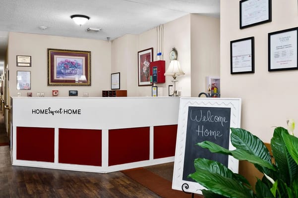 Welcoming reception desk with a sign that says 'Home Sweet Home'