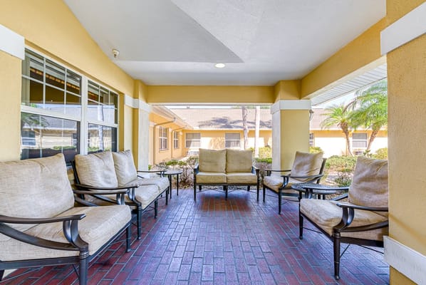 Cozy porch area with seating at Sun City Senior Living