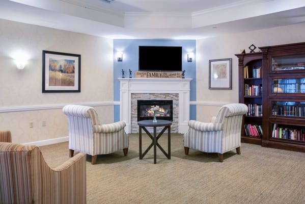 Comfortable seating area with a fireplace in a senior living facility