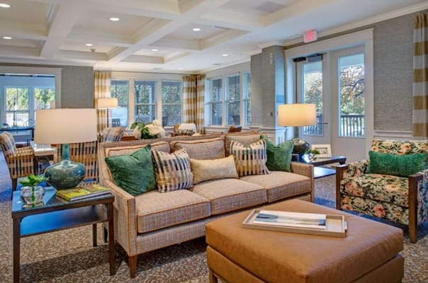 Cozy living room with sofas, armchairs, and natural light