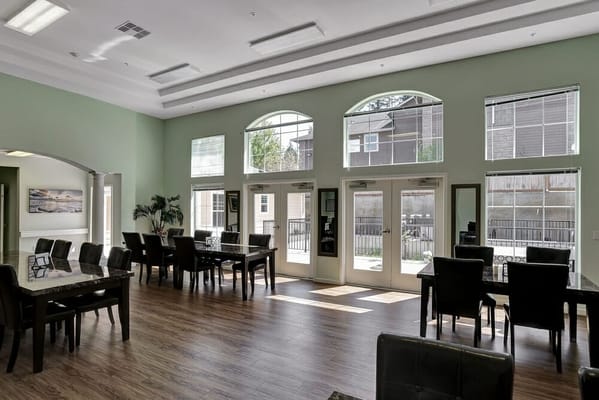 Bright dining area with large windows and seating
