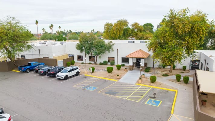 Exterior view of Tempe Post Acute facility with parking