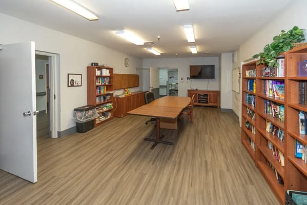 Interior view of a common area with shelves and a table