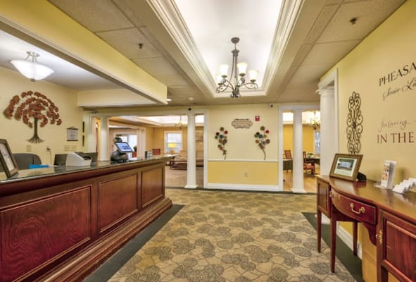 View of the reception area with a wooden desk and decorations