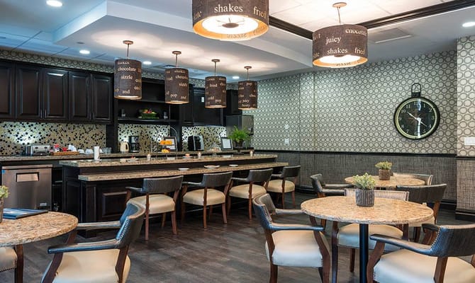 Modern dining area with tables and chairs, and stylish pendant lighting