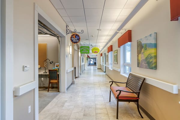 Brightly lit hallway with signage and seating