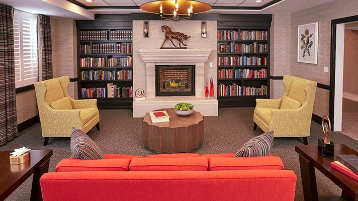Cozy common area with seating and a bookshelf