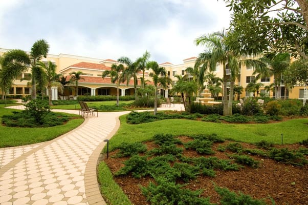 Scenic view of the landscaped garden with pathways and seating at The Carlisle Naples.
