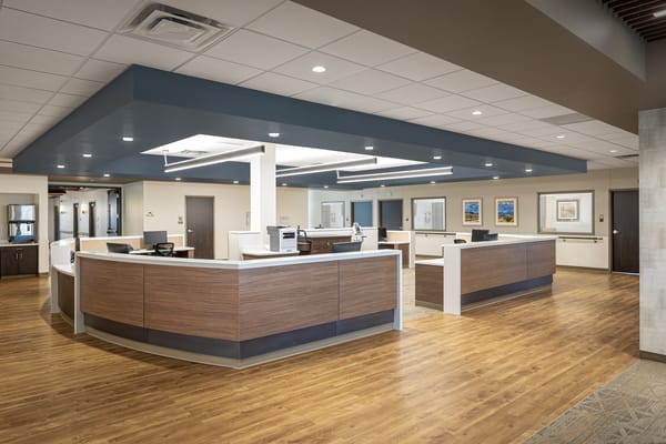 Modern reception area with wooden desks and light fixtures