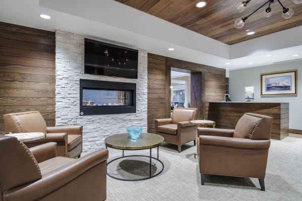 Cozy lounge area with leather chairs and a fireplace