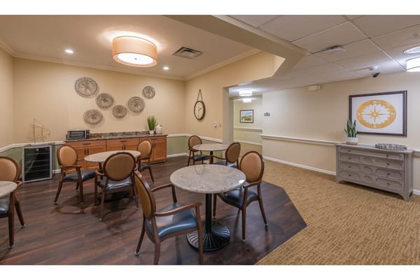 Common area with tables and chairs in a bright interior