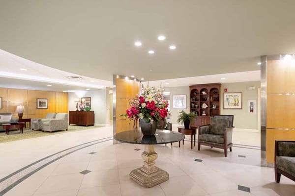 Bright lobby with floral arrangement and seating area