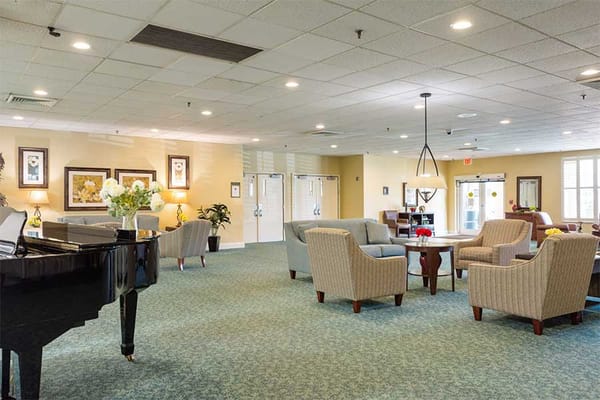 Spacious lobby area with seating and a piano.