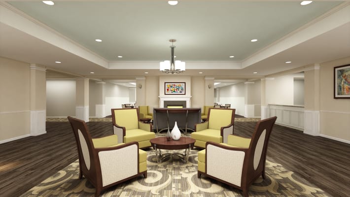 A modern living room with yellow seating and a coffee table in The Crossings at Riverchase.