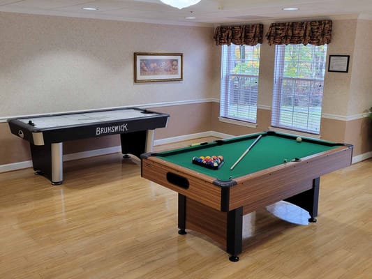 An interior room with a pool table and air hockey table