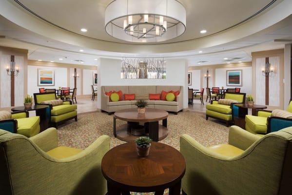 Lounge area featuring colorful seating and a round table