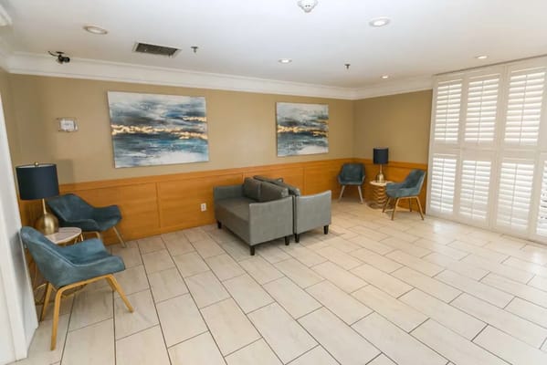 Modern lounge area with seating and artwork