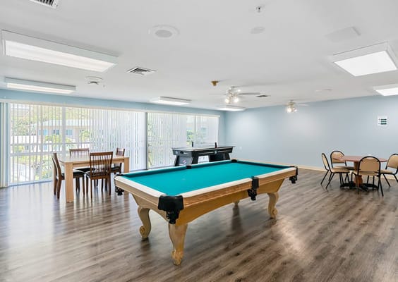 Spacious recreation room with pool table and dining area