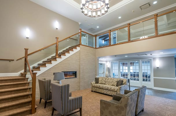 Bright common area with seating and staircase
