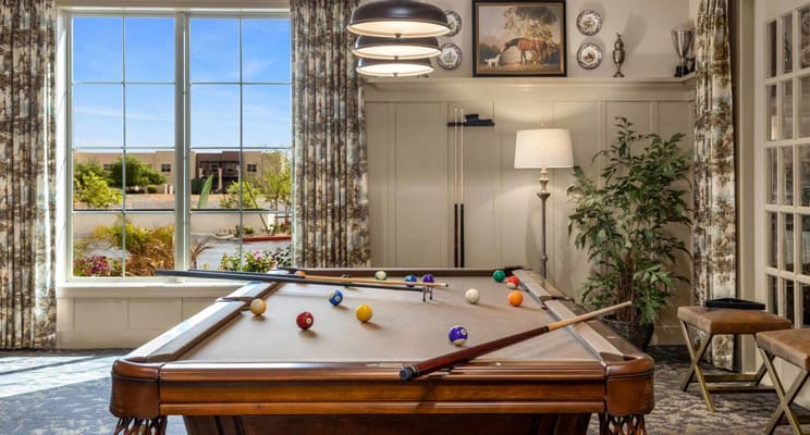 Billiards table with colorful balls in a bright room
