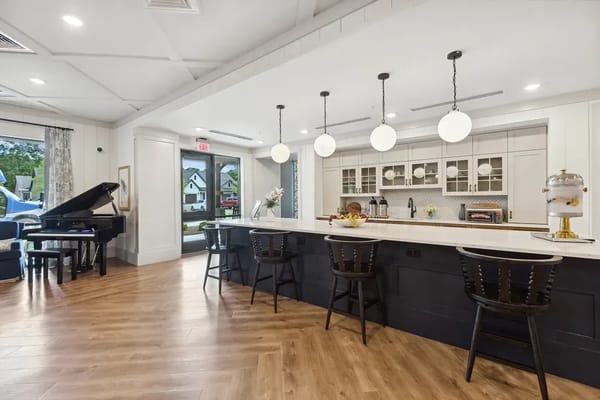 Bright kitchen lounge with seating and piano