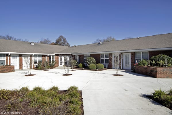 Outdoor courtyard with landscaped gardens and pathways
