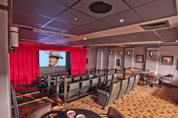 Interior view of the movie theater with seating and a large screen