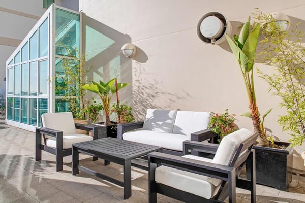 Outdoor patio area with seating and greenery