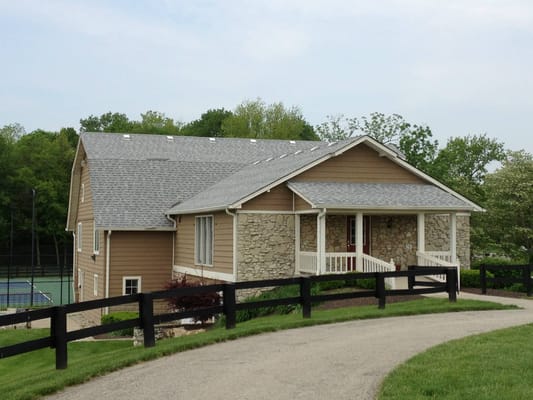 Exterior of a senior living facility showing a stone and wood building