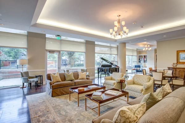 Comfortable living room with a grand piano and seating area.