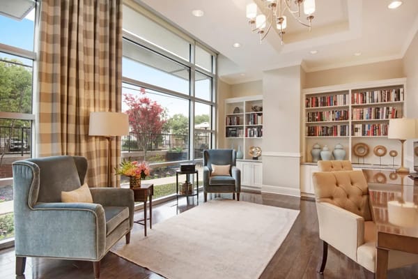 Cozy living room with two armchairs, a coffee table, and bookshelves
