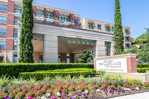 Exterior view of The Village of Tanglewood facility with flowers
