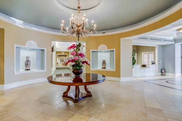 Interior view of a brightly lit lobby with floral arrangements