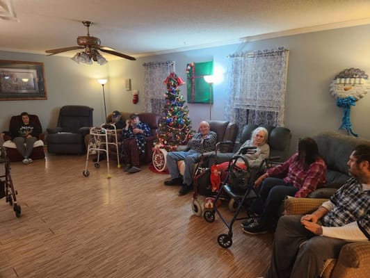 Residents enjoying time in a cozy common area decorated for the holidays