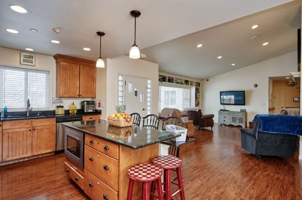 Bright common area in a senior living facility with kitchen