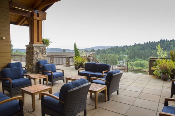 Cozy seating area with chairs and tables overlooking a scenic view