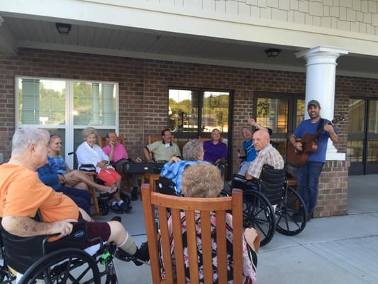 Residents enjoying music outdoors at Trinity Elms.