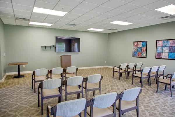 Empty meeting room with chairs and a television.
