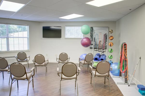 Empty exercise room with fitness equipment and seating