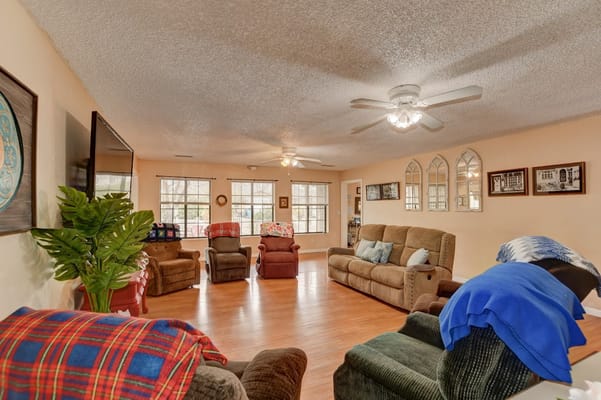 Spacious and comfortable living room with seating and natural light.